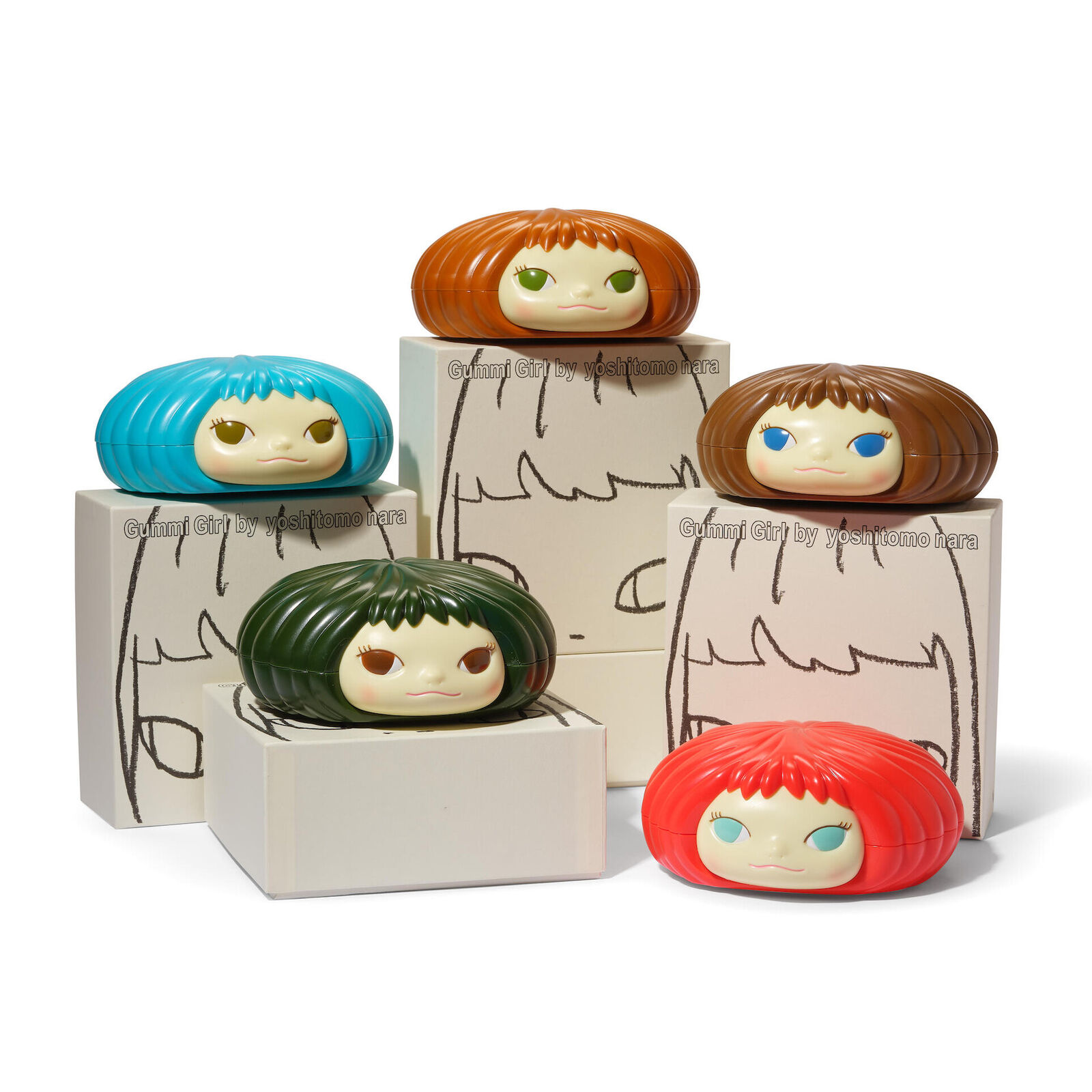 A group of four different colored dolls sitting on top of each other.