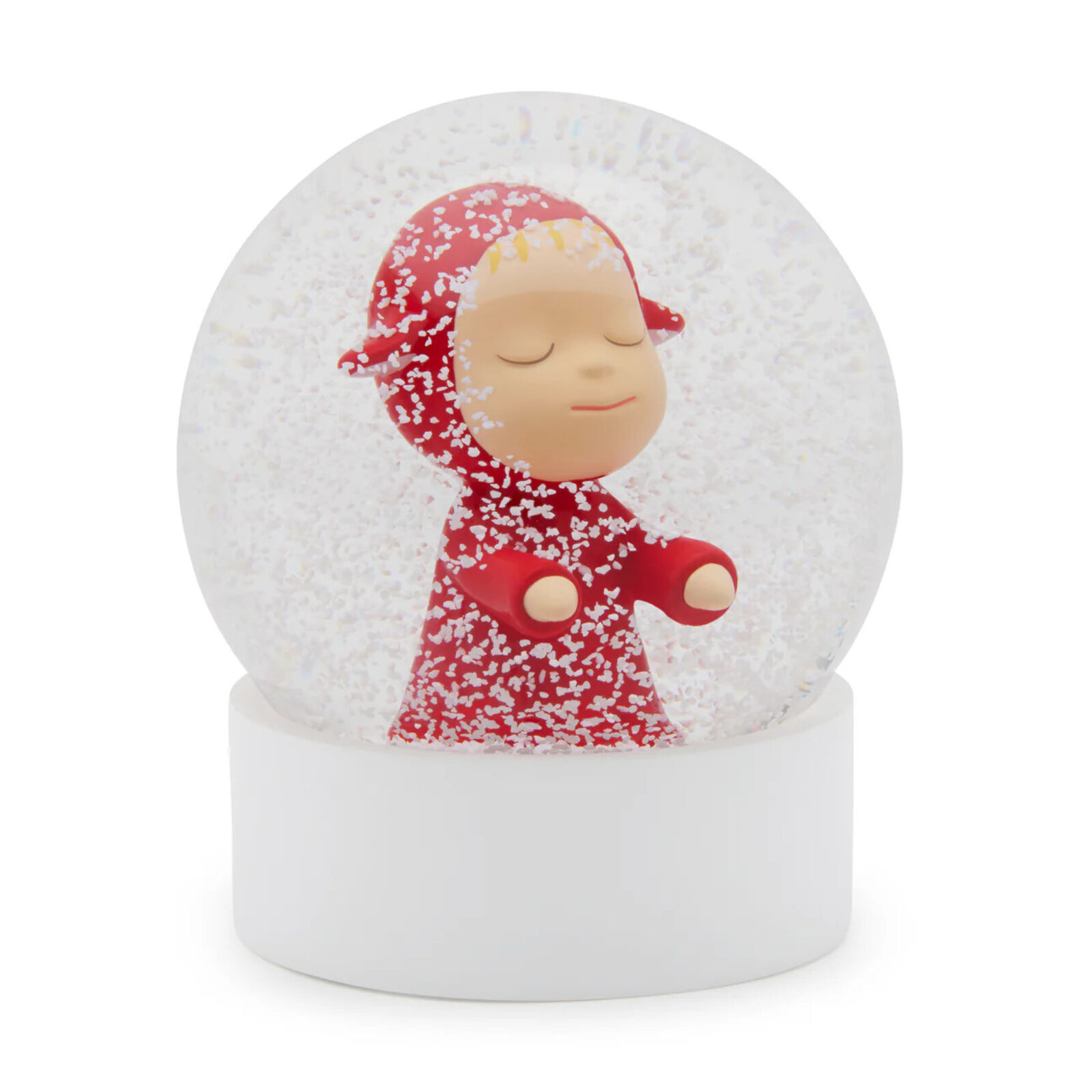 A snow globe with a little girl in a red dress.