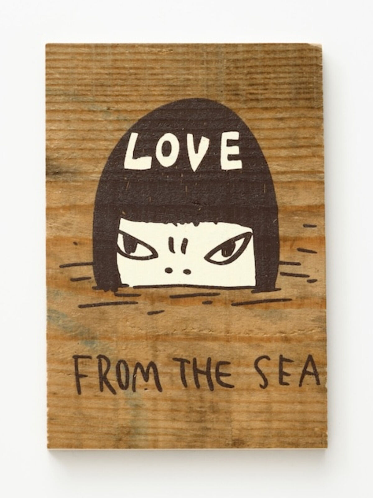 A wooden sign that says love from the sea.