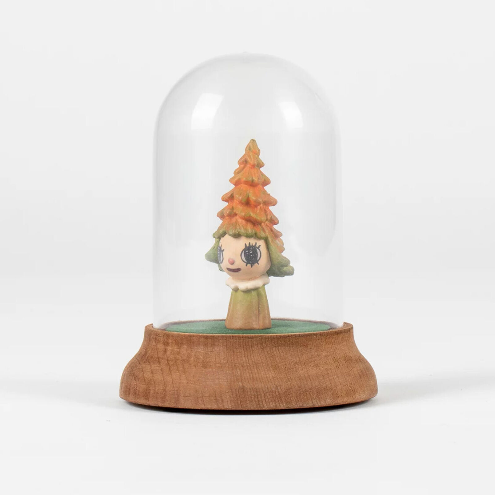 A small figurine of a little girl under a glass dome.