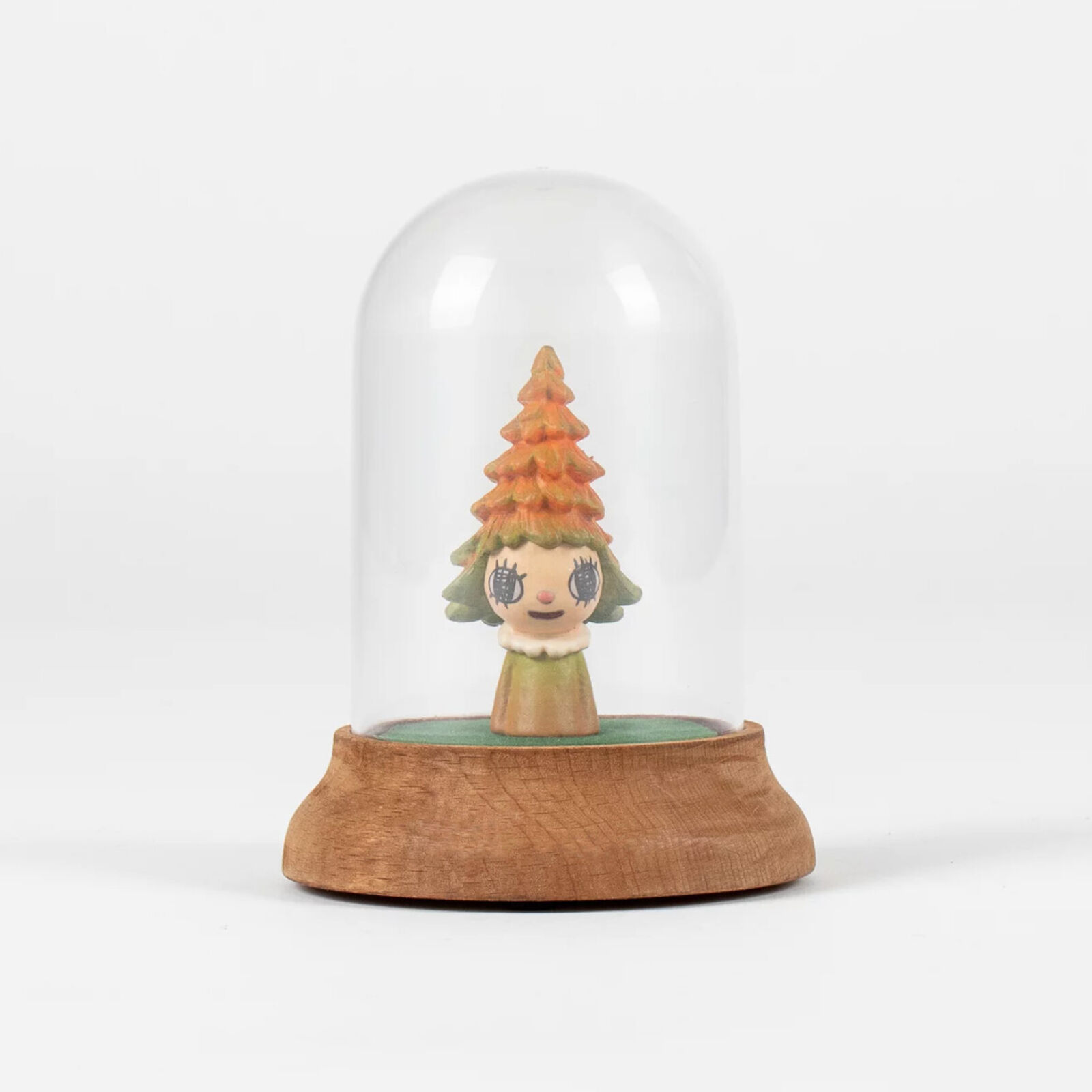 A small figurine of a little girl under a glass dome.