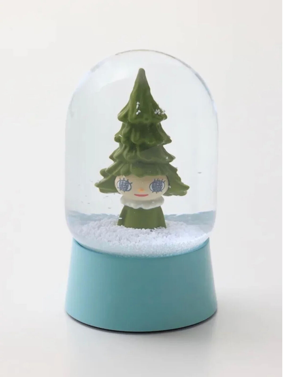 A snow globe with a small christmas tree inside of it.