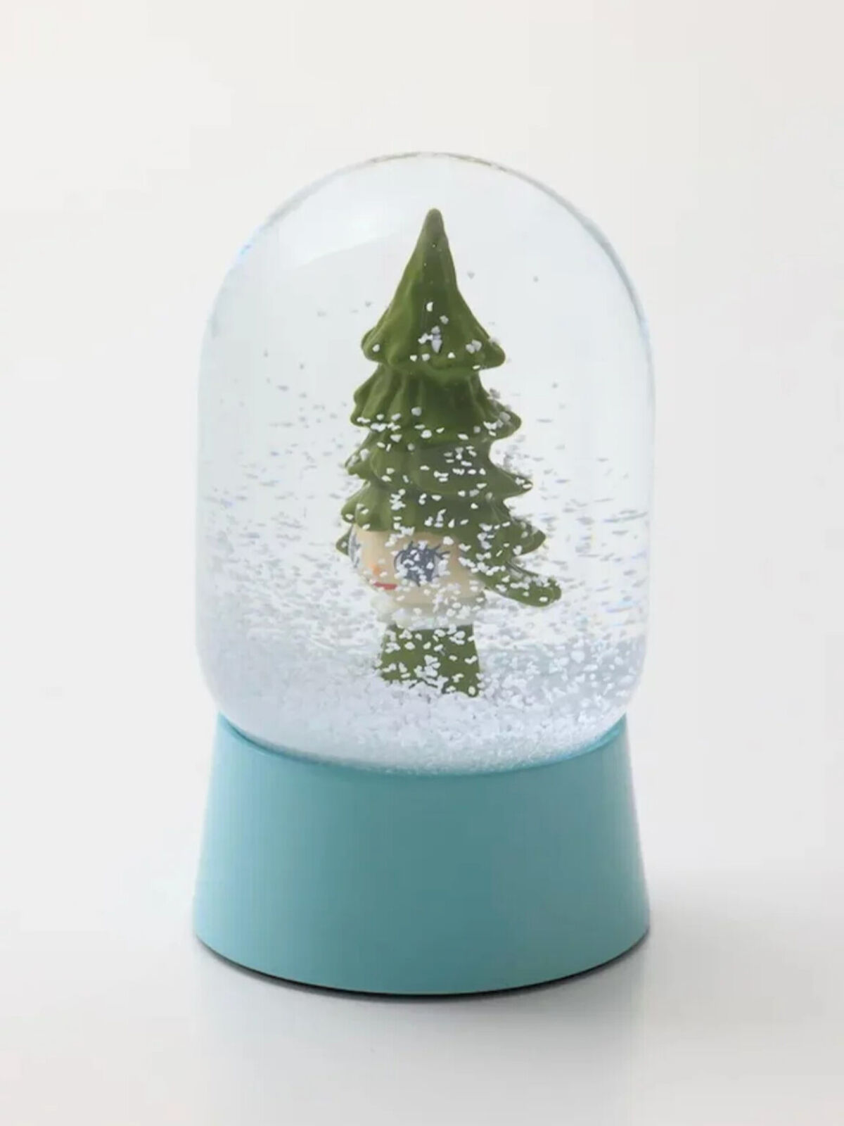 A snow globe with a small christmas tree inside of it.