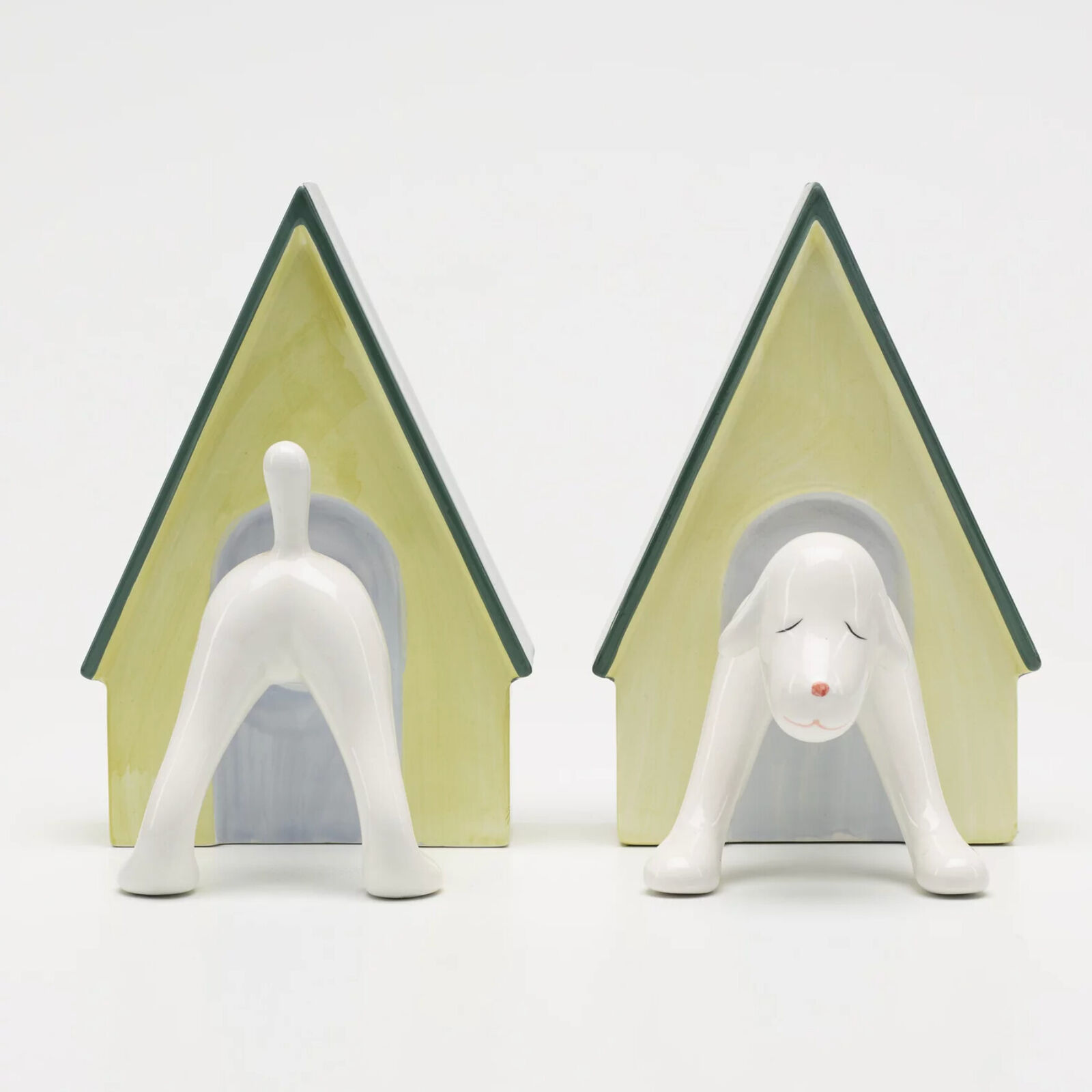 A pair of bookends with a dog and a doghouse.