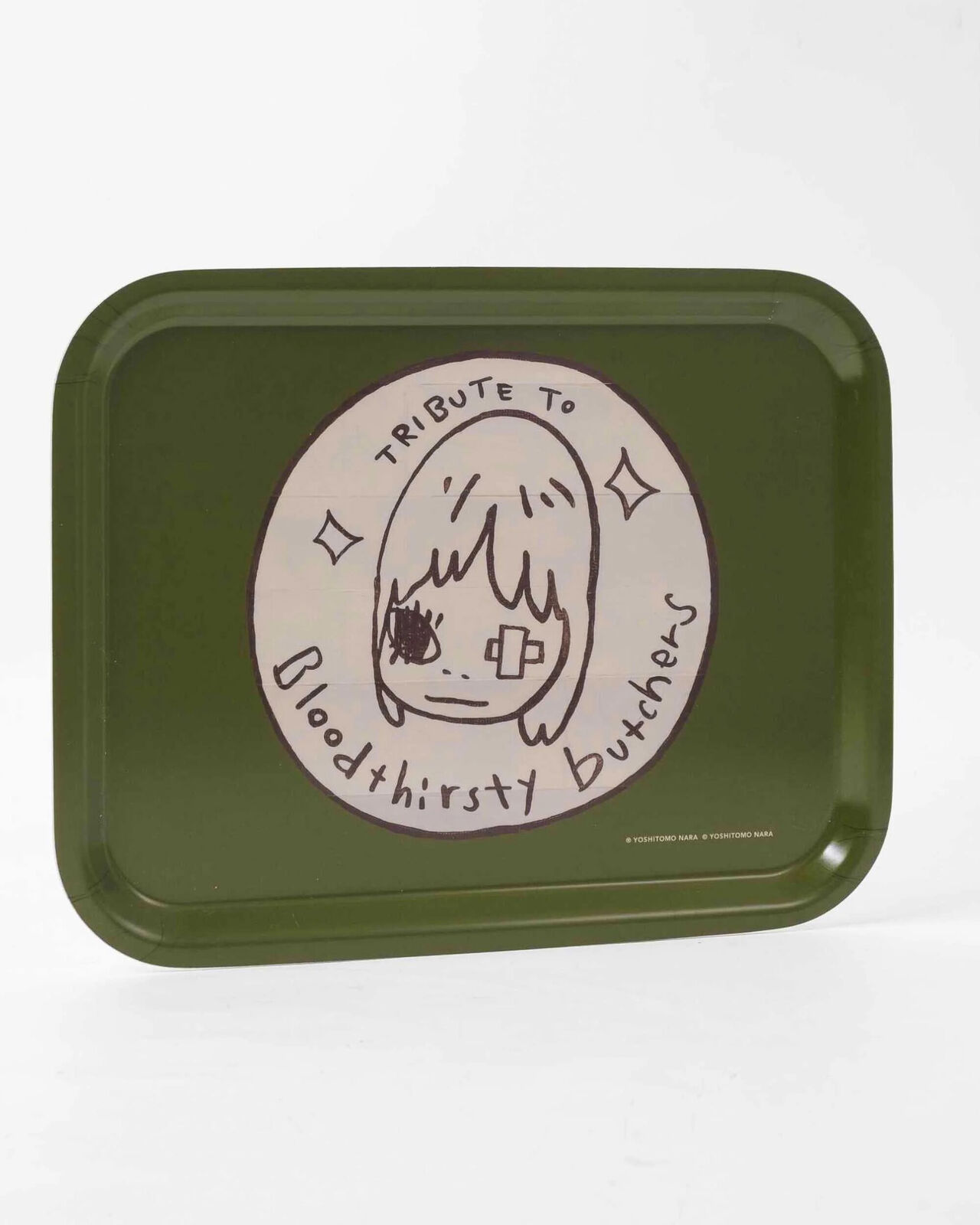 A green tray with a drawing of a girl's face on it.