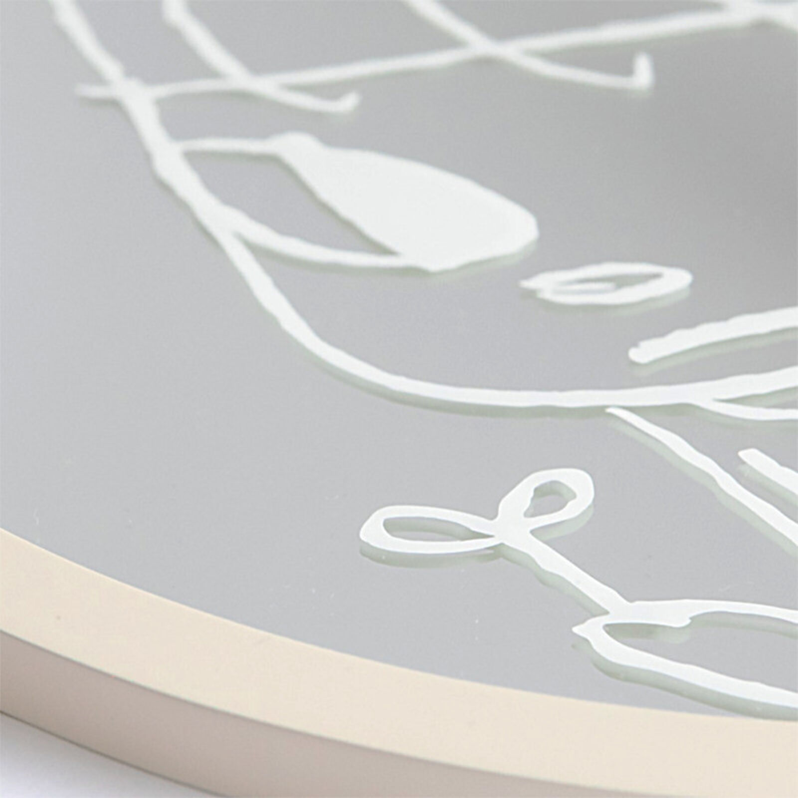 A round mirror with a drawing of a girl holding a flower.