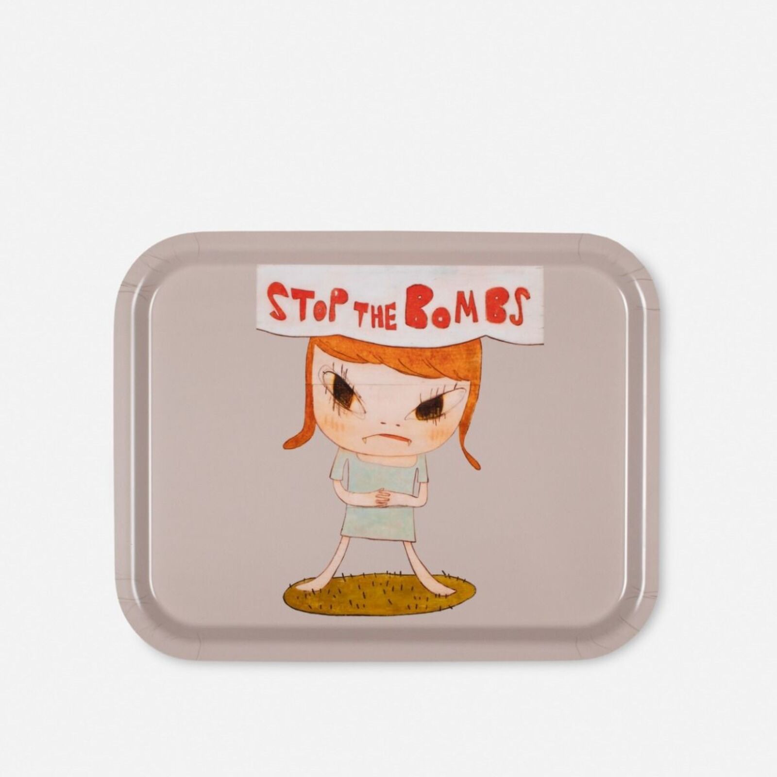 A small tray with a cartoon girl holding a sign that says stop the bombs.