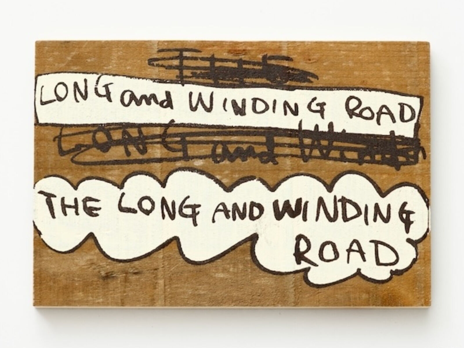 A wooden sign that says long and winding road.