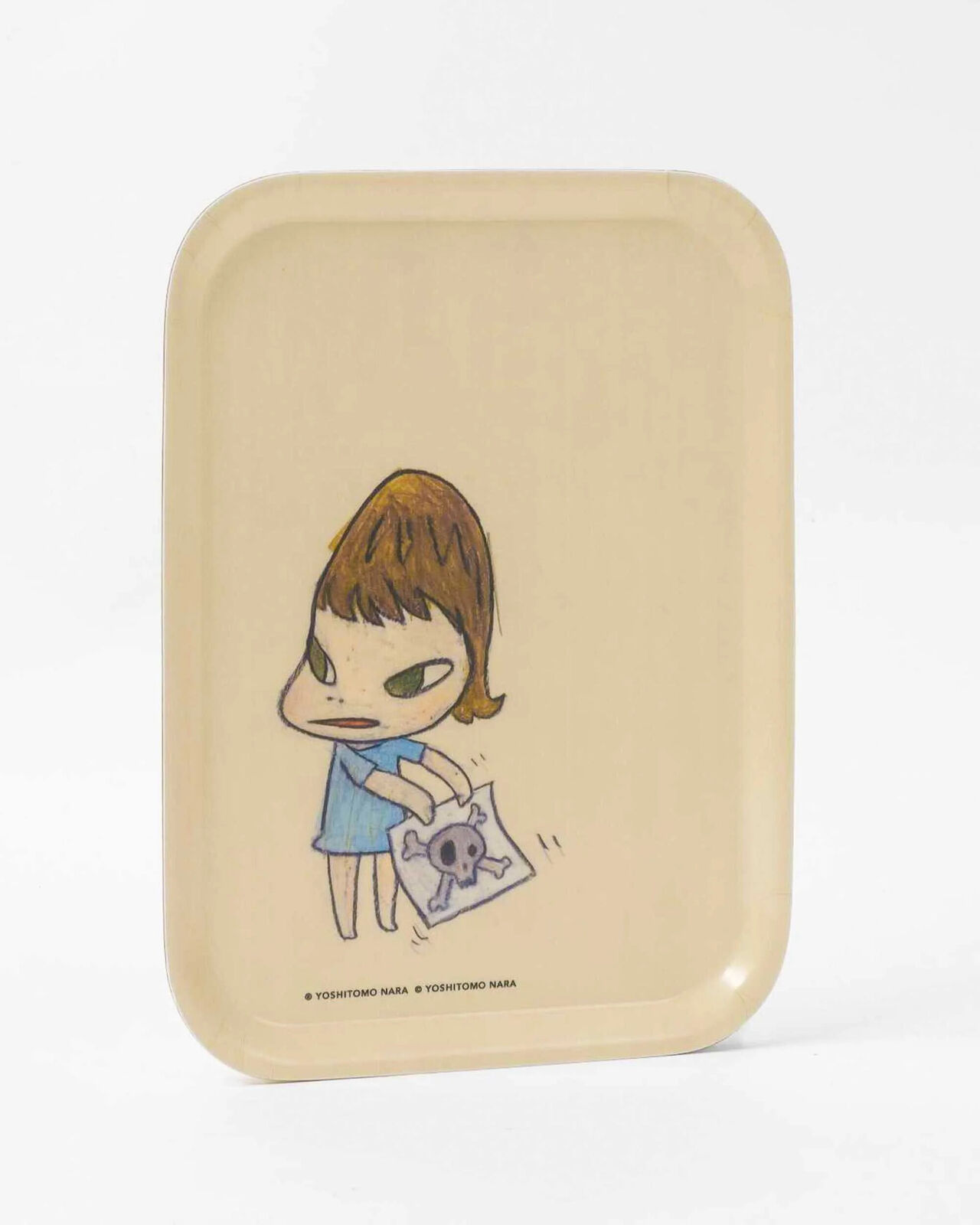 A small tray with a drawing of a little girl reading a book.
