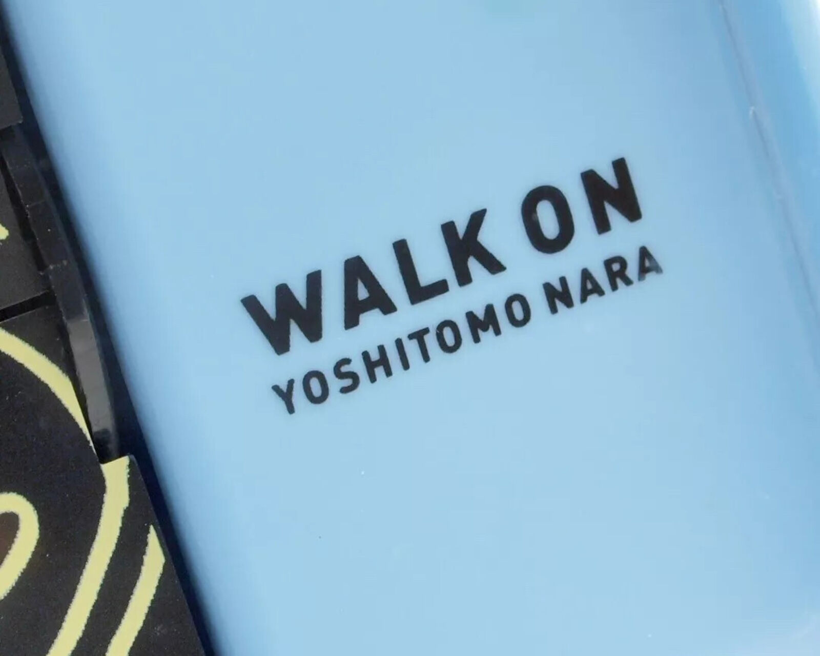 A blue alarm clock with a picture of a boy and a girl on it.