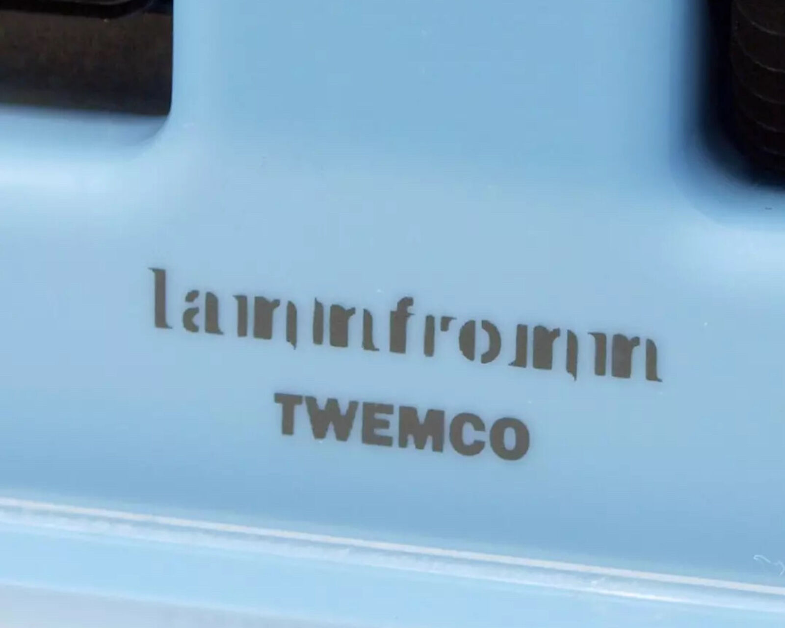 A blue alarm clock with a picture of a boy and a girl on it.