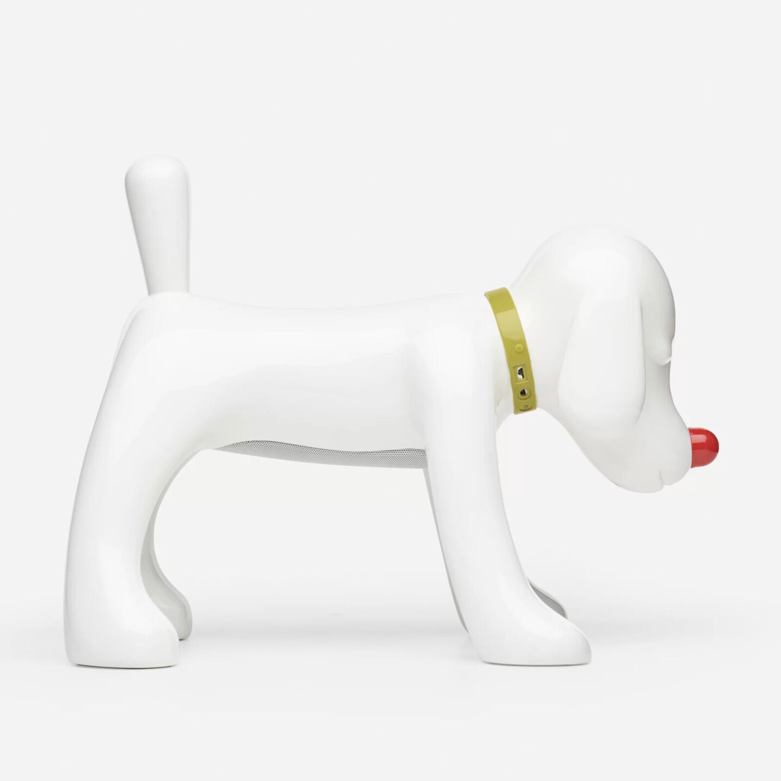 A white dog figurine with a red nose and a yellow collar.