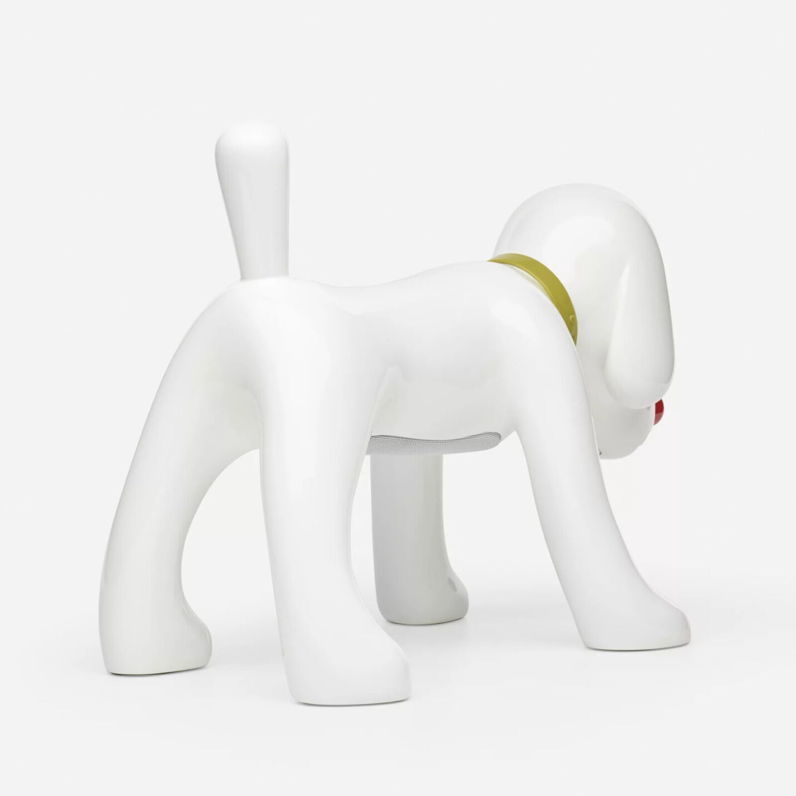 A white dog figurine with a red nose and a yellow collar.