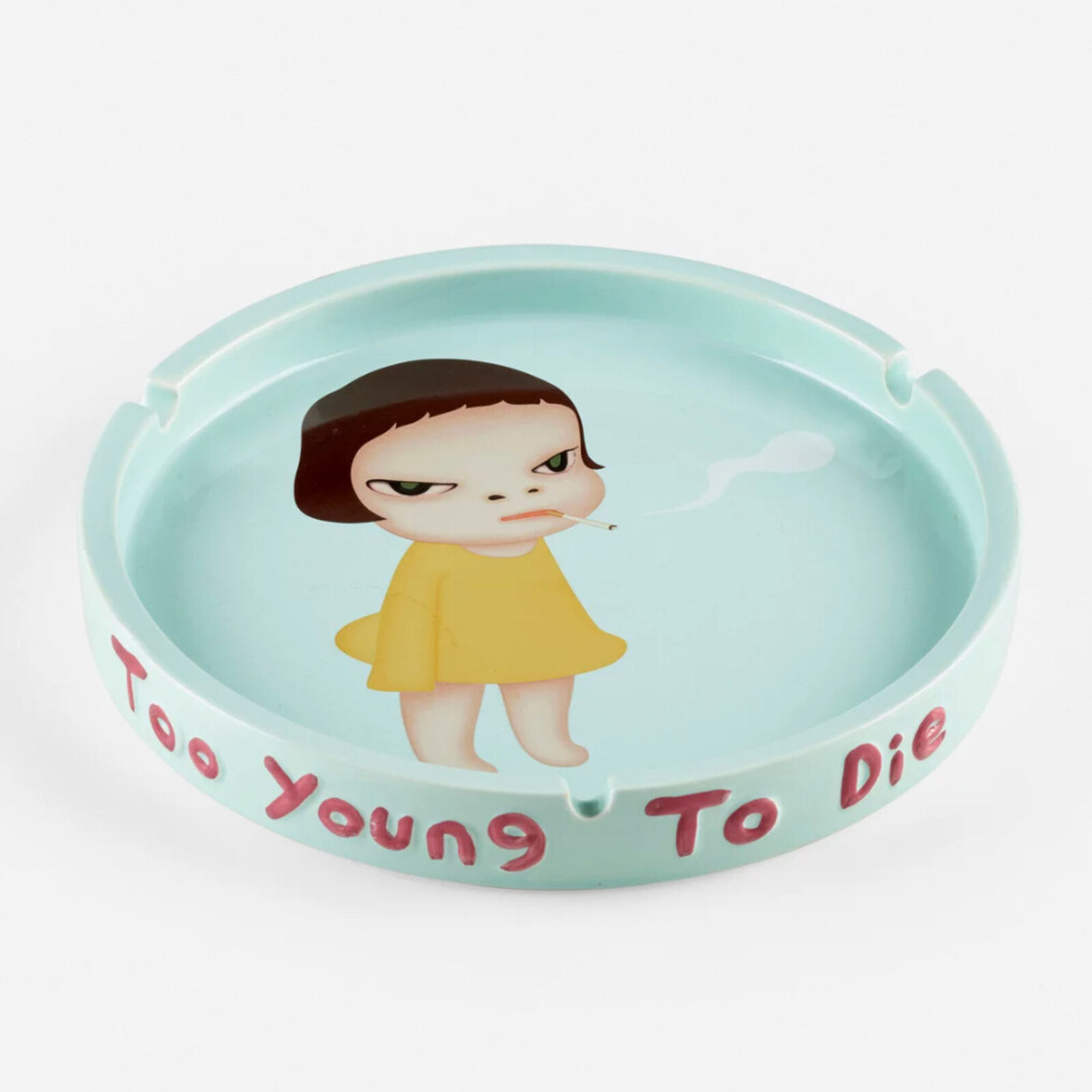 A plate with a little girl smoking a cigarette.