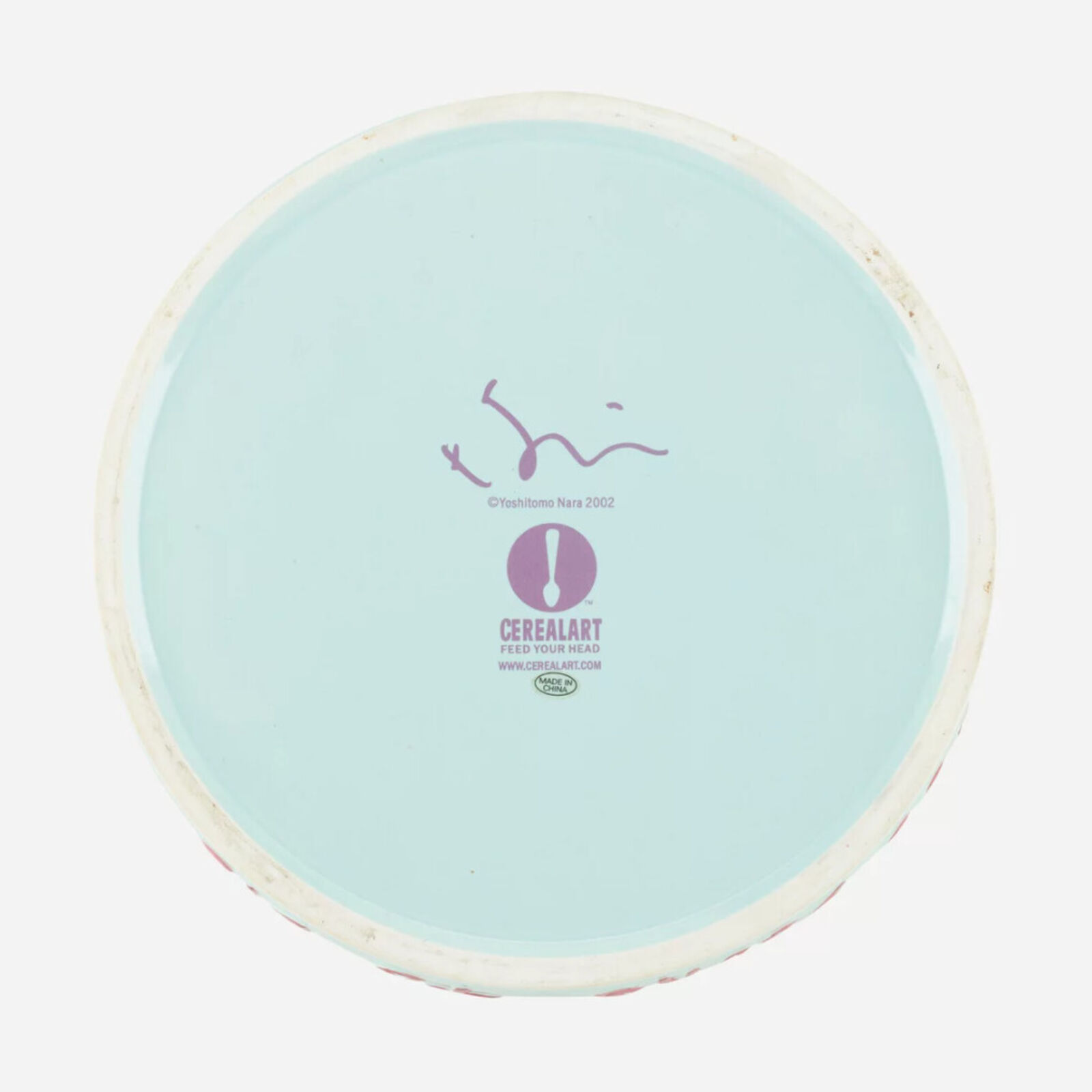 A plate with a little girl smoking a cigarette.