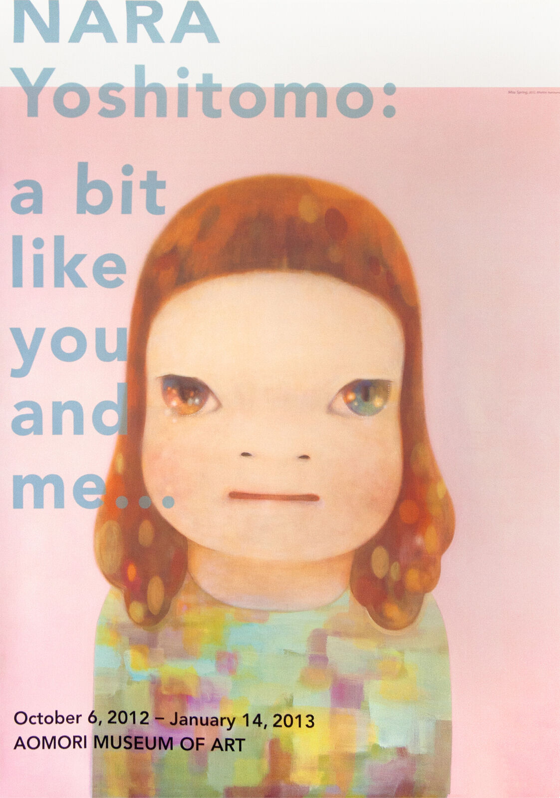 A poster with a picture of a girl's face on it.