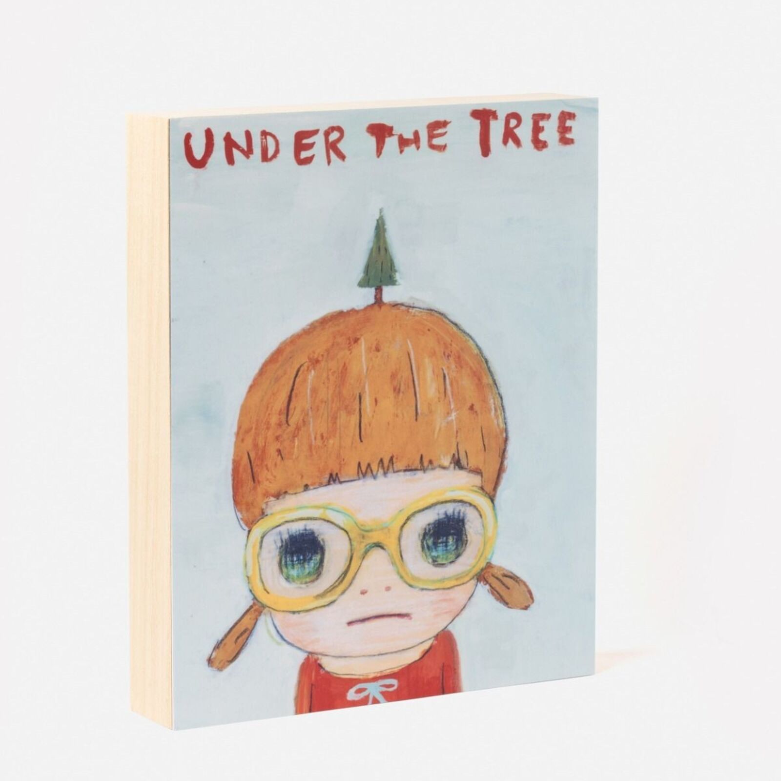 A picture of a child with glasses and a christmas tree on his head.