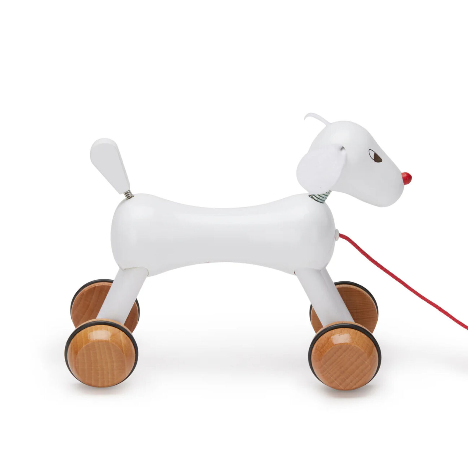 A wooden toy dog pulling a red leash.