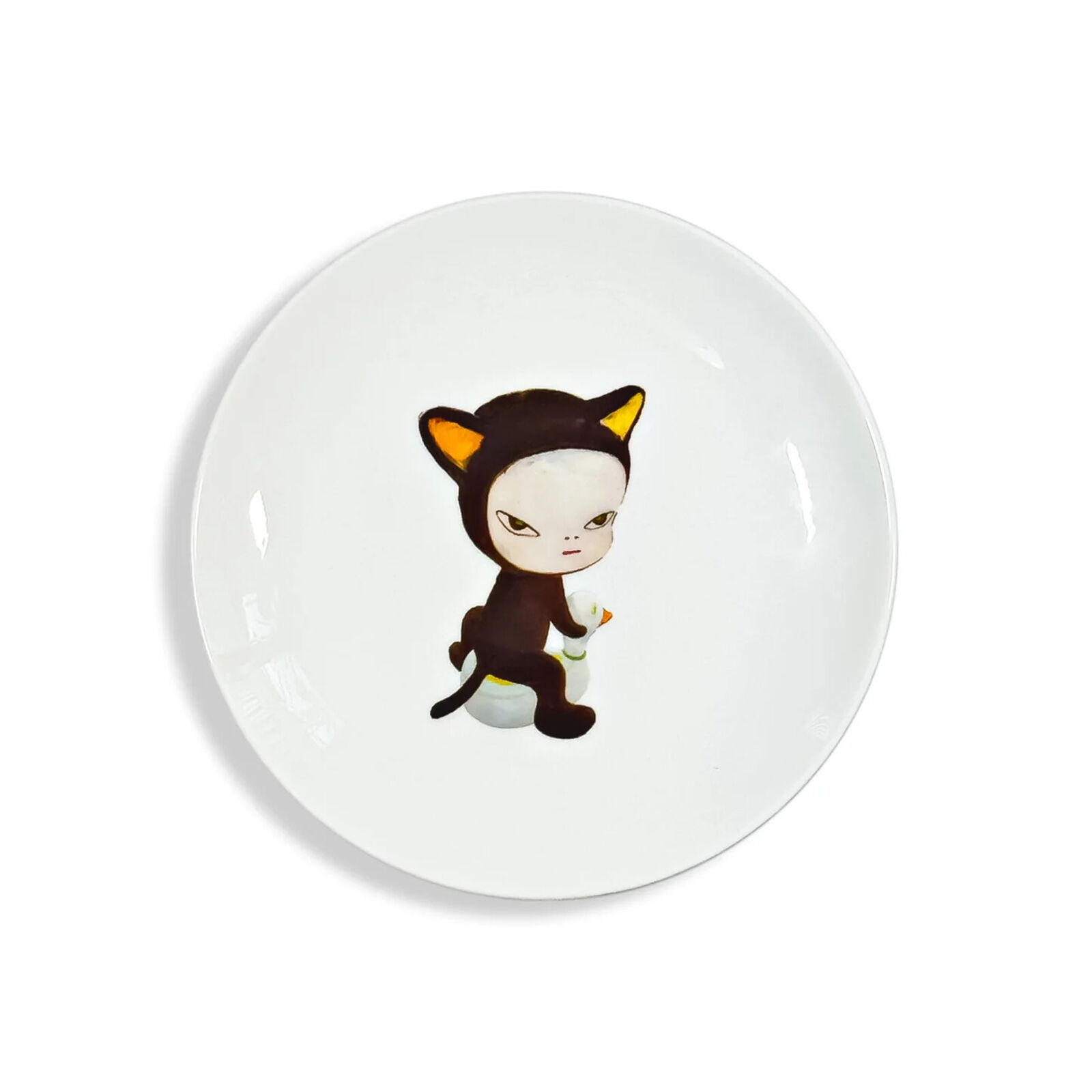 A white plate with a cartoon cat sitting on top of it.