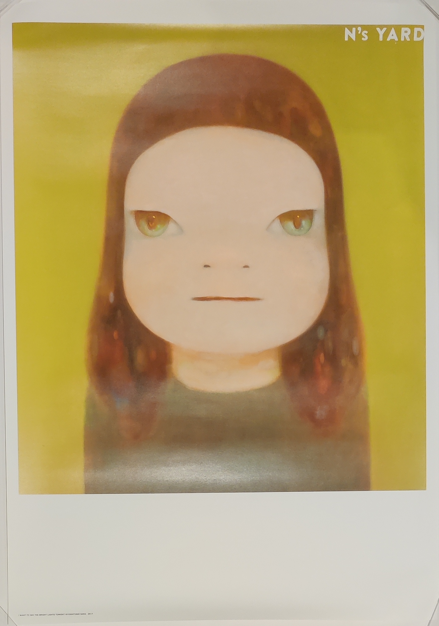 A picture of a girl with green eyes on a yellow background.