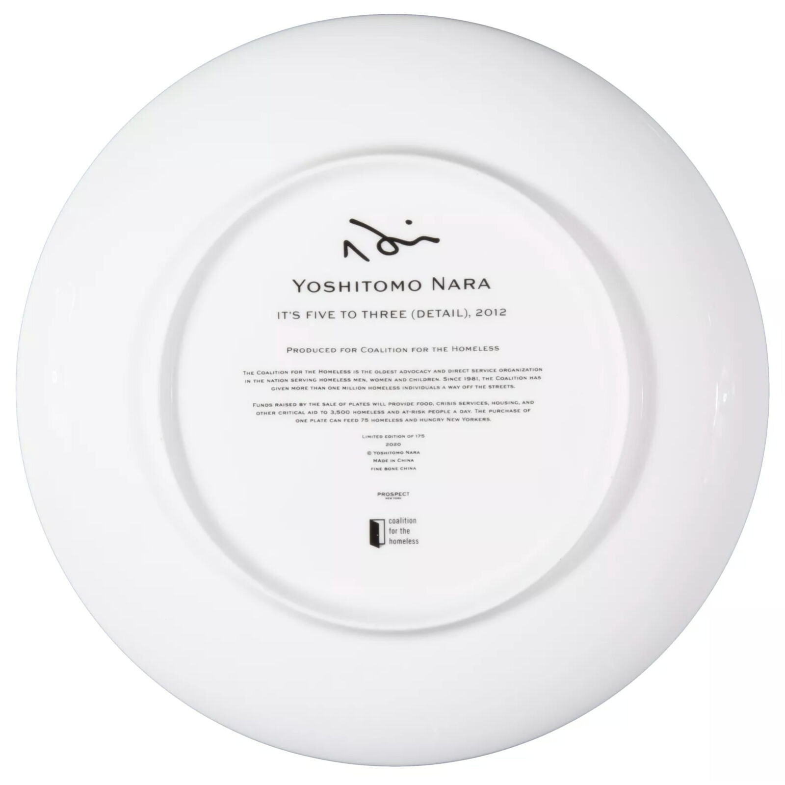 A plate with a drawing of a girl sitting at a table.