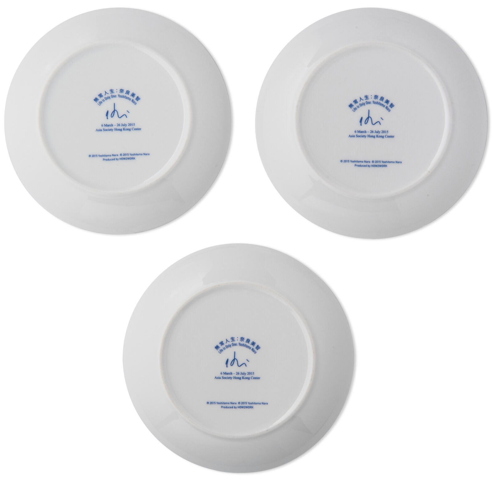 A set of three blue and white plates with cartoon characters on them.