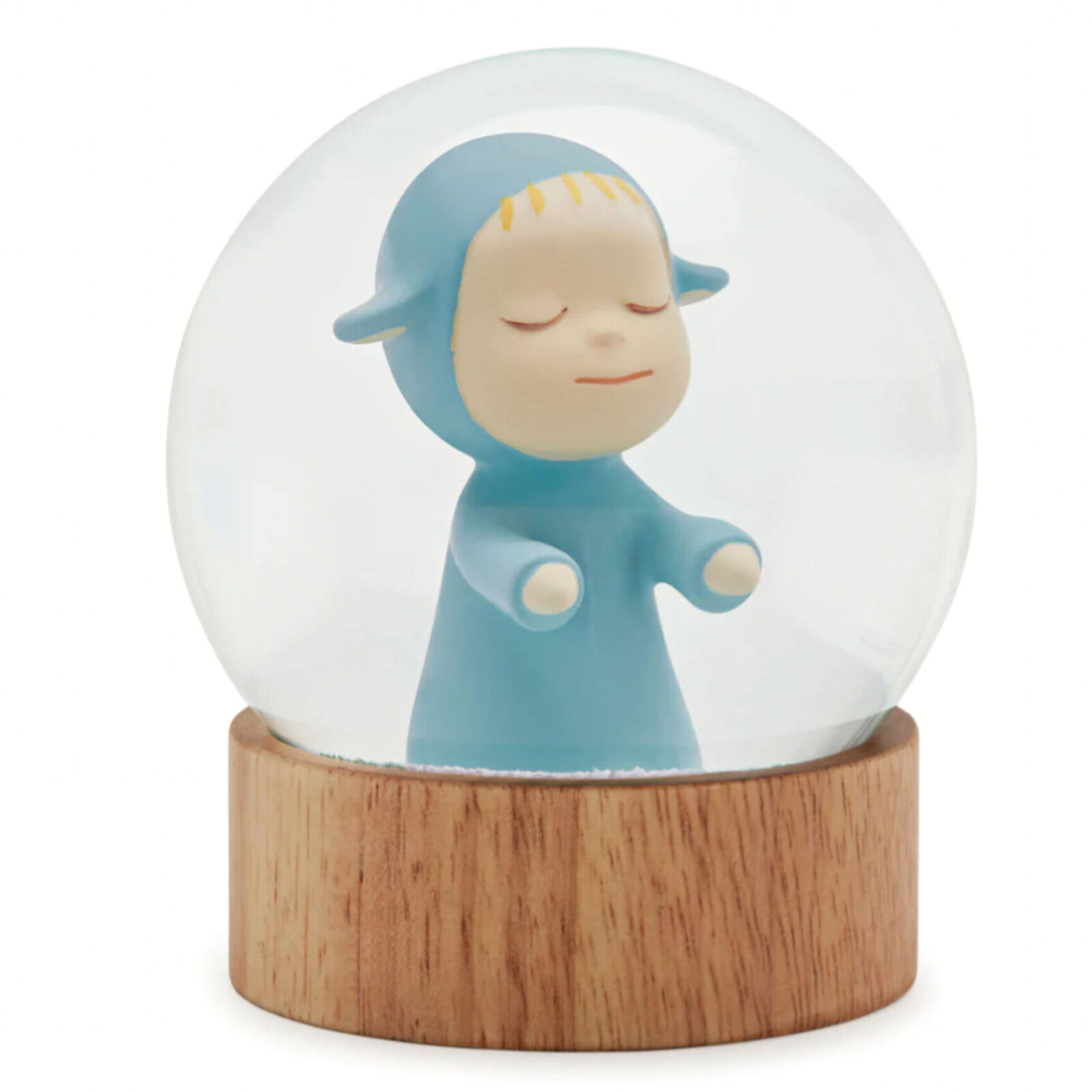 A snow globe with a little boy in a blue outfit.