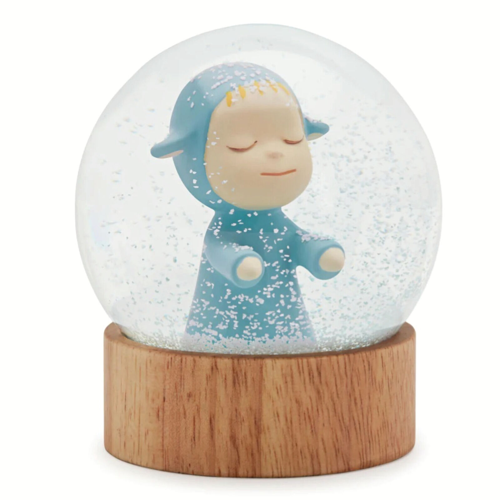 A snow globe with a little boy in a blue outfit.