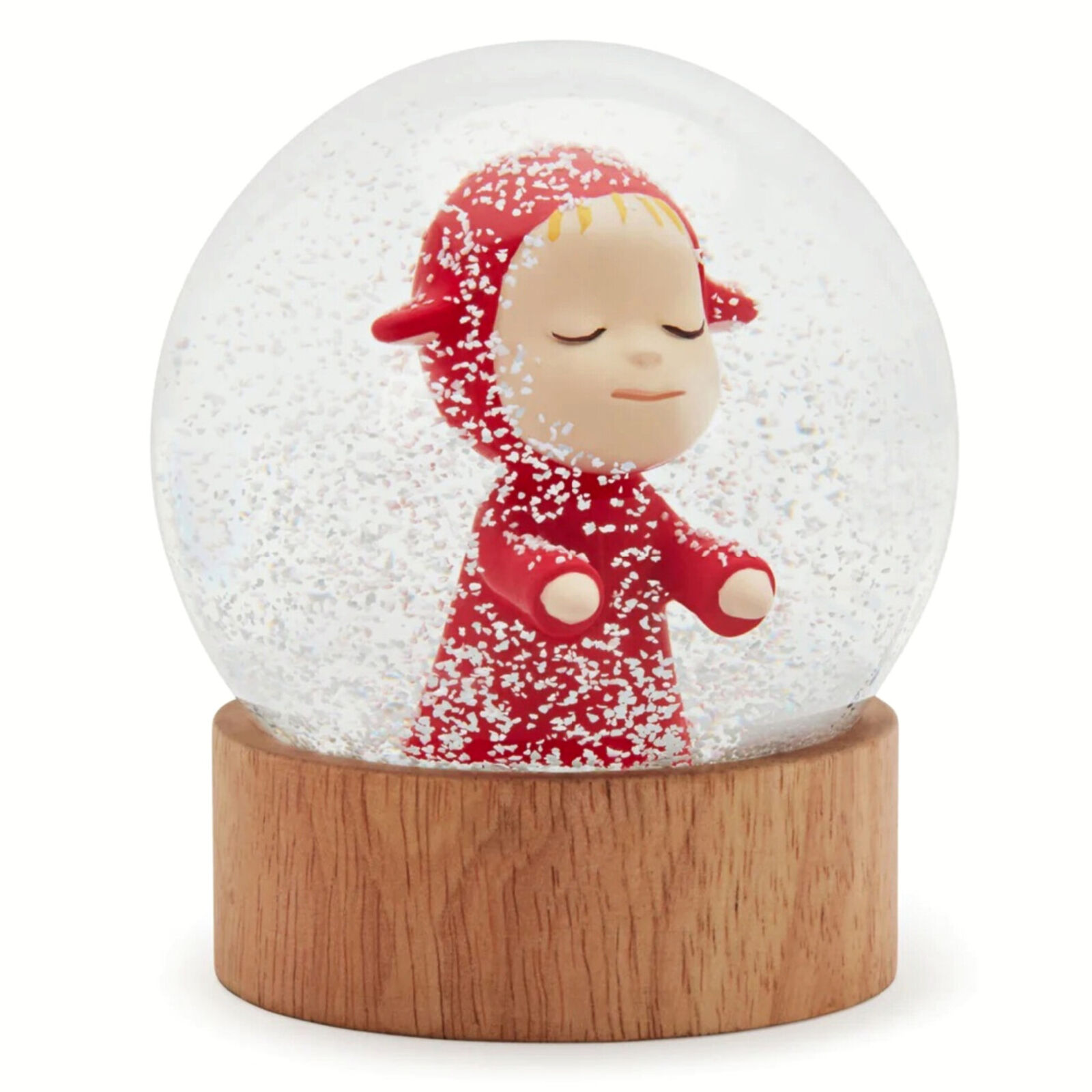A snow globe with a little girl in a red dress.