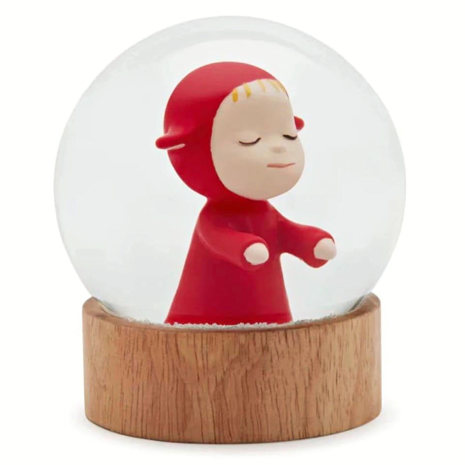A snow globe with a little girl in a red dress.