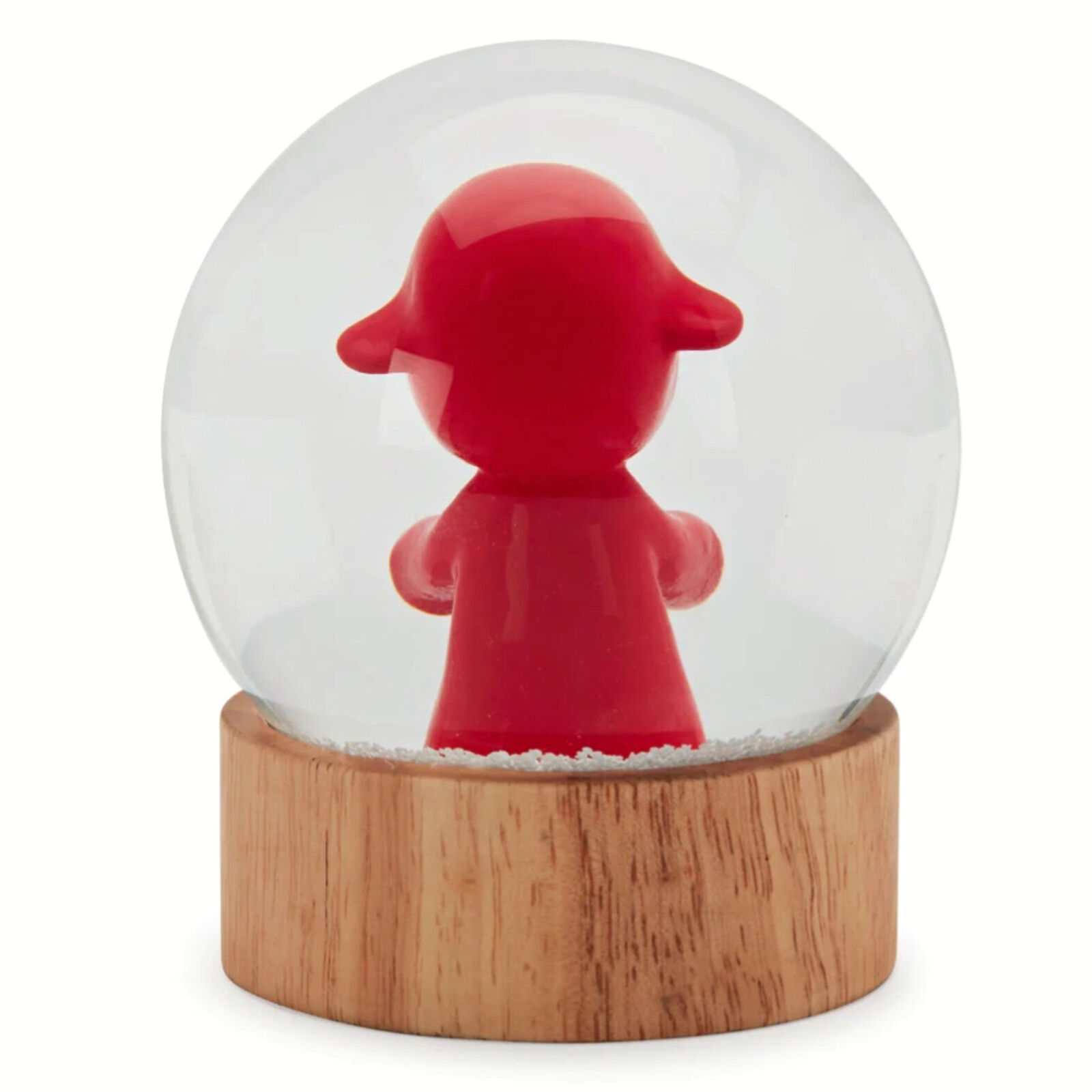 A snow globe with a little girl in a red dress.
