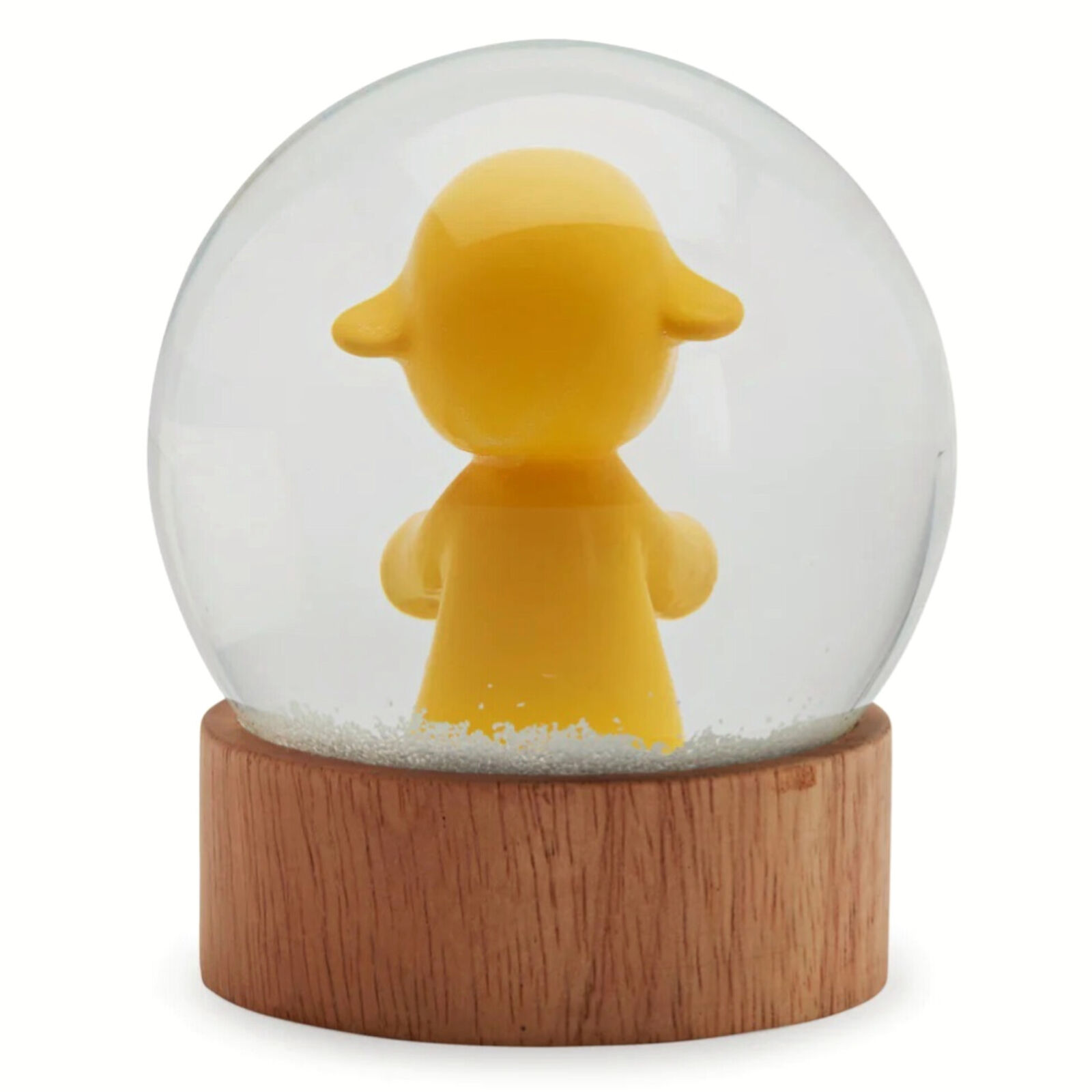 A snow globe with a little girl in a yellow dress.