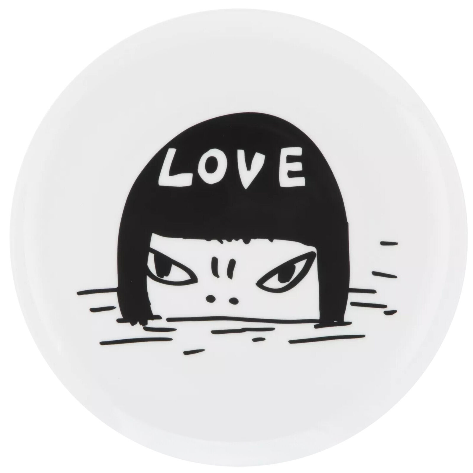 A white plate with a black and white drawing of a woman's face in the water.