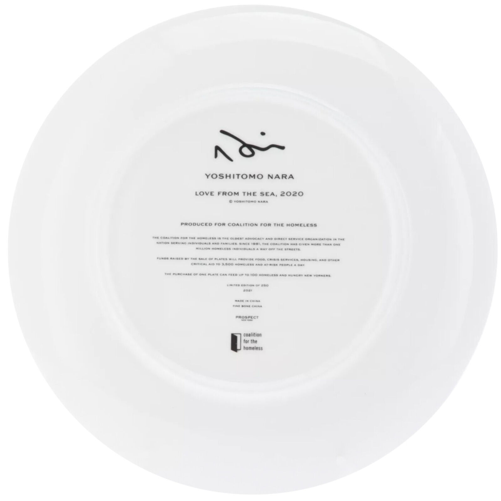 A white plate with a black and white drawing of a woman's face in the water.