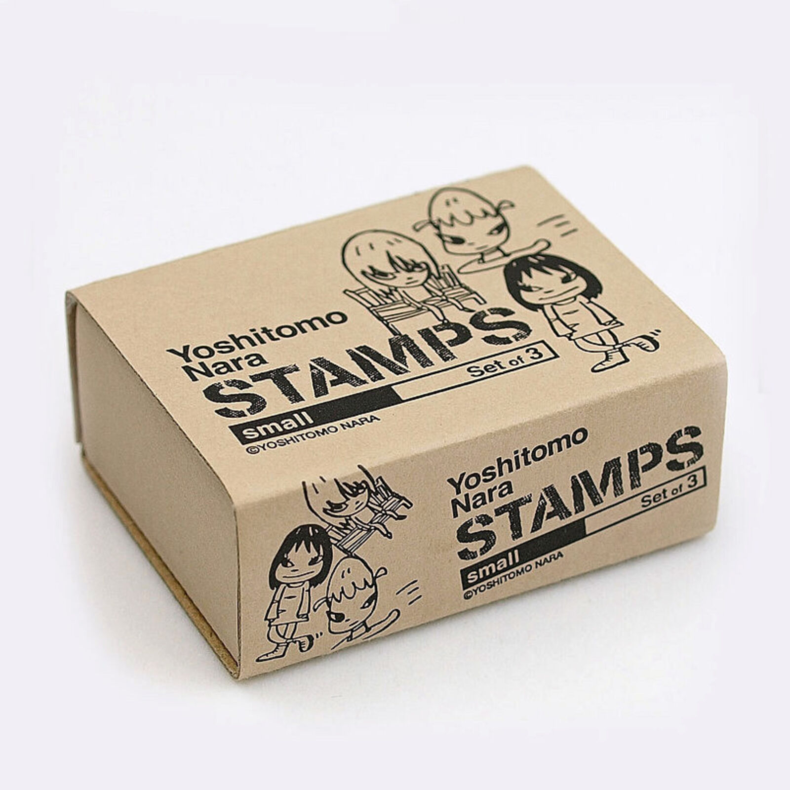 A set of three wooden blocks with a drawing of a girl sitting on a chair.