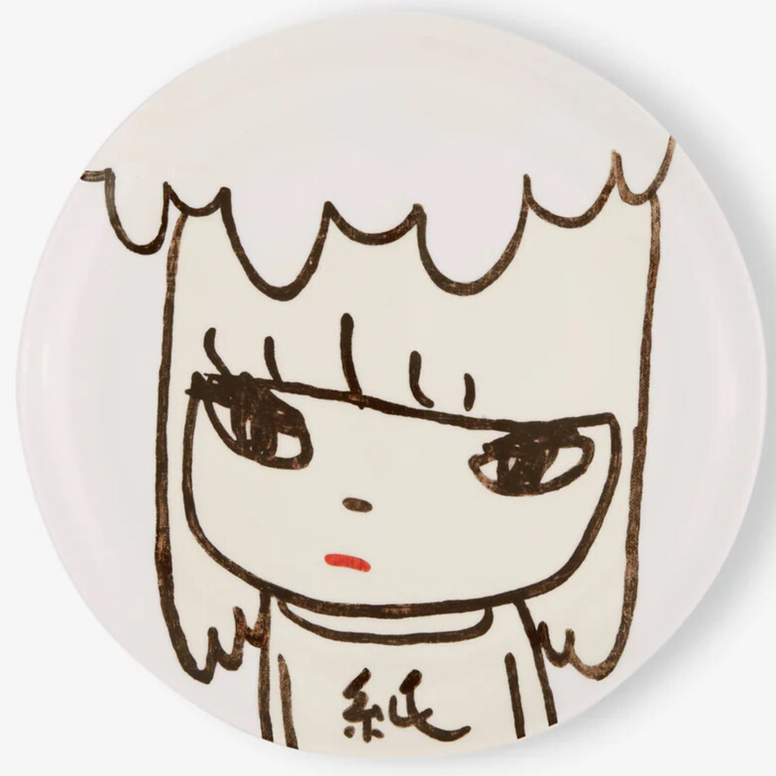 A white plate with a drawing of a girl's face.