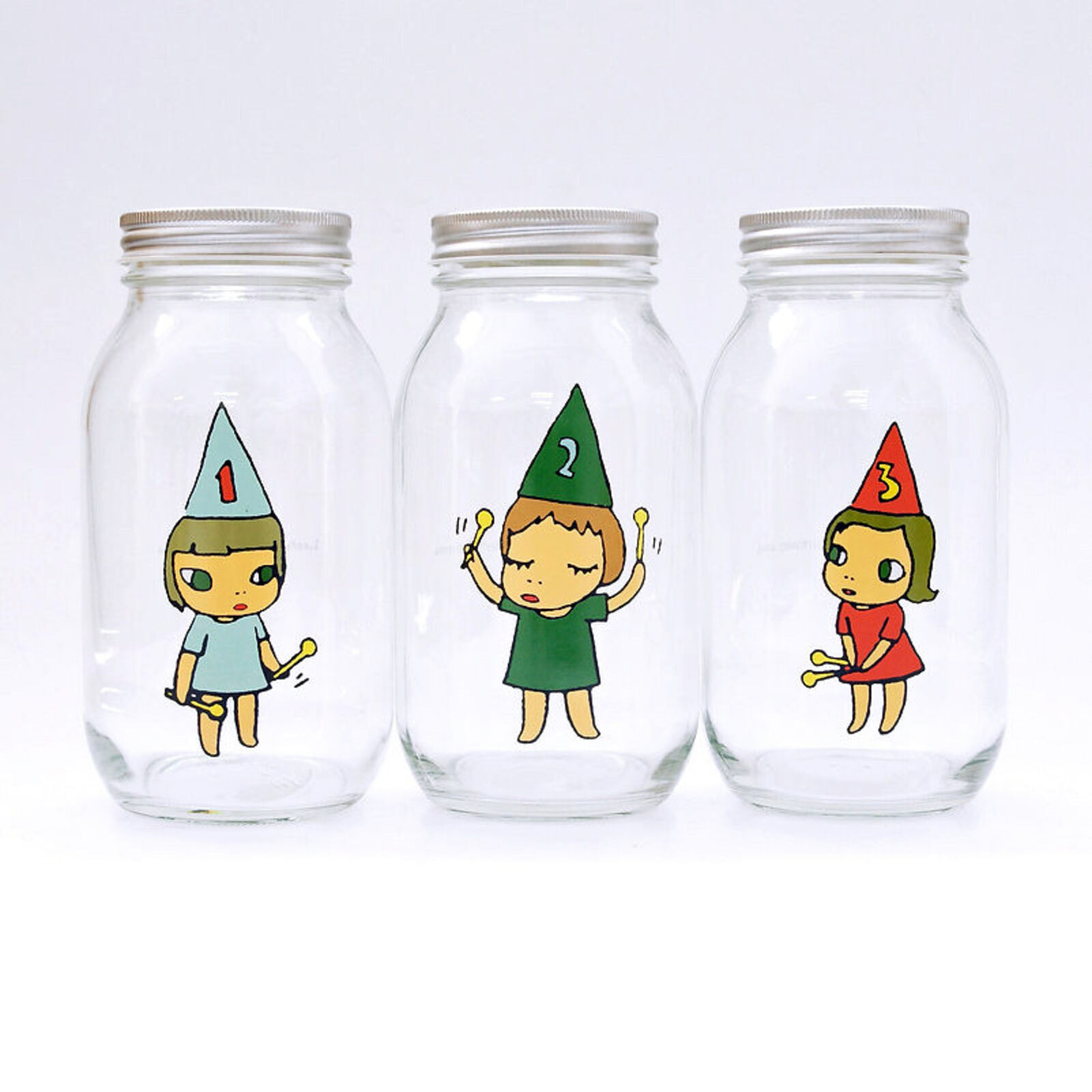 A set of three glass jars with cartoon characters on them.