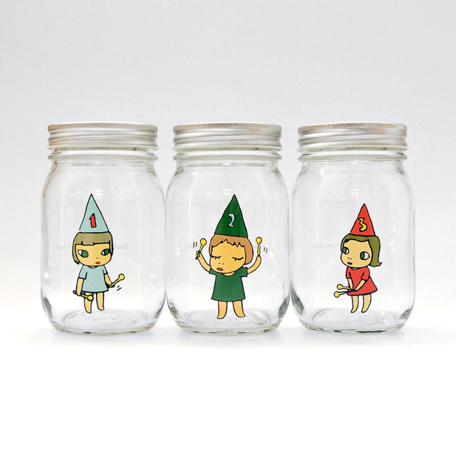 A set of three glass jars with cartoon characters on them.