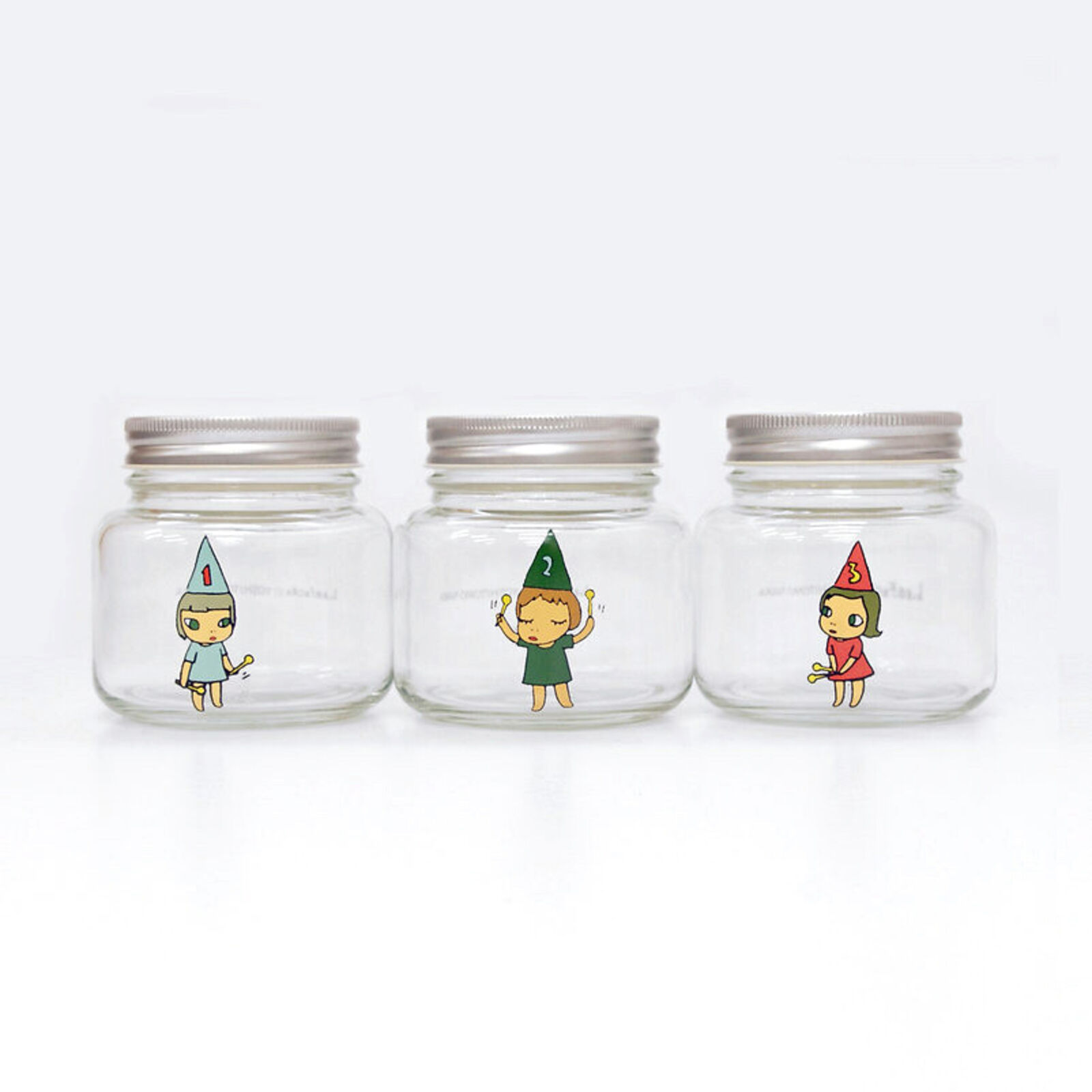 A set of three glass jars with cartoon characters on them.