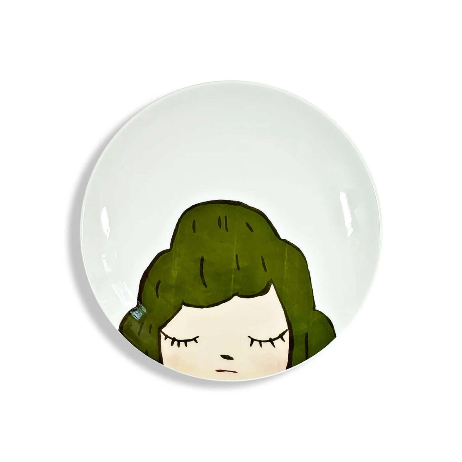 A plate with a drawing of a girl's face on it.