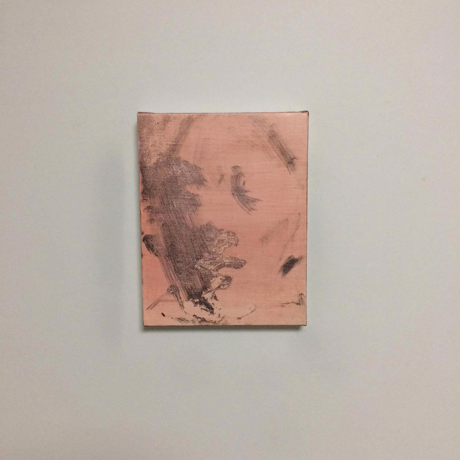 A minimalist abstract painting featuring a pink canvas with dark, textured brushstrokes.