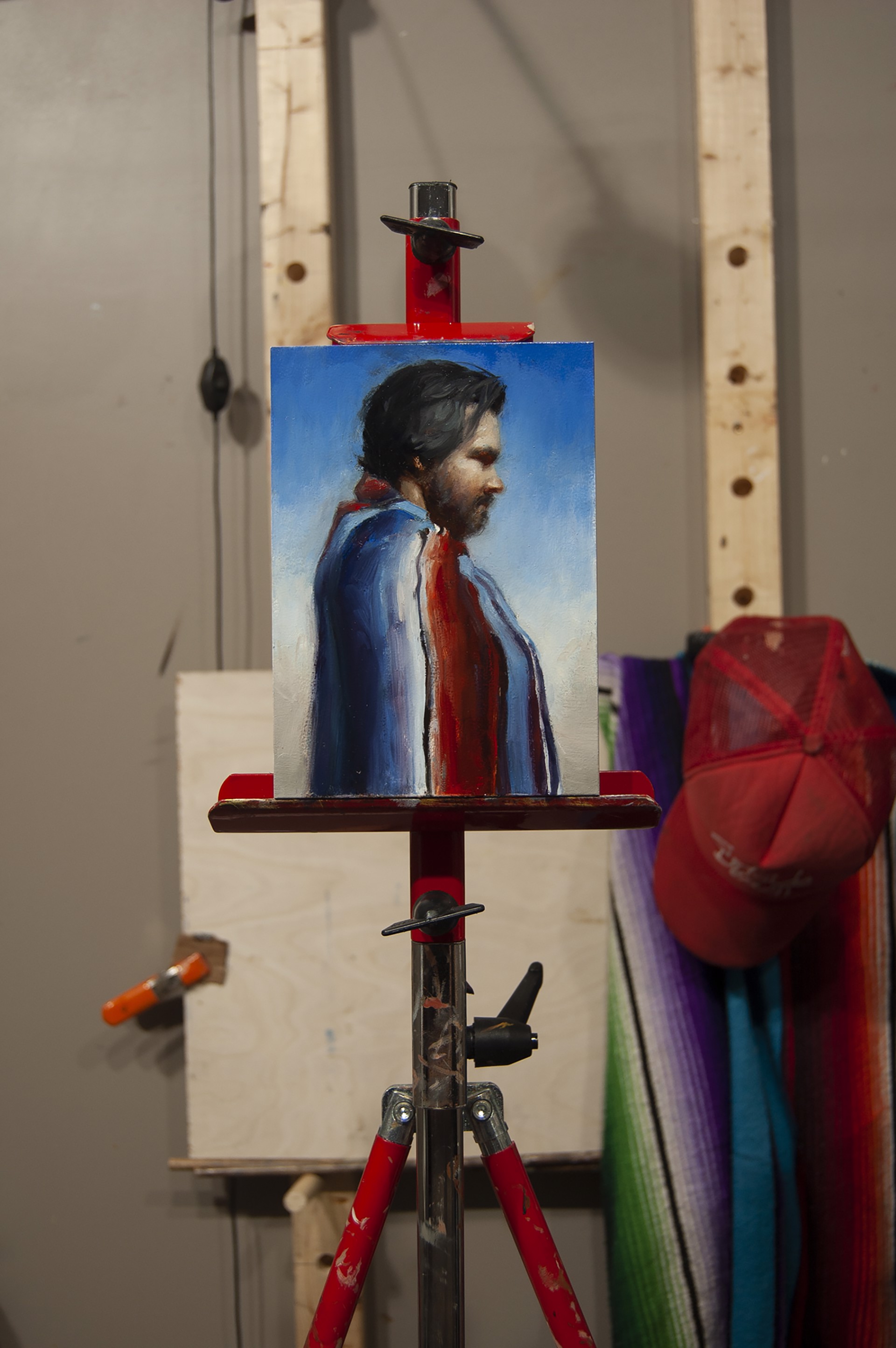 A painting of a man with a red scarf.