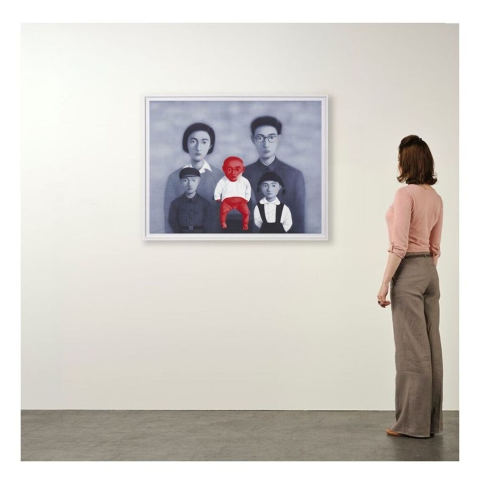 A surreal portrait of a family where one child is rendered in vivid red against a desaturated blue-grey background.