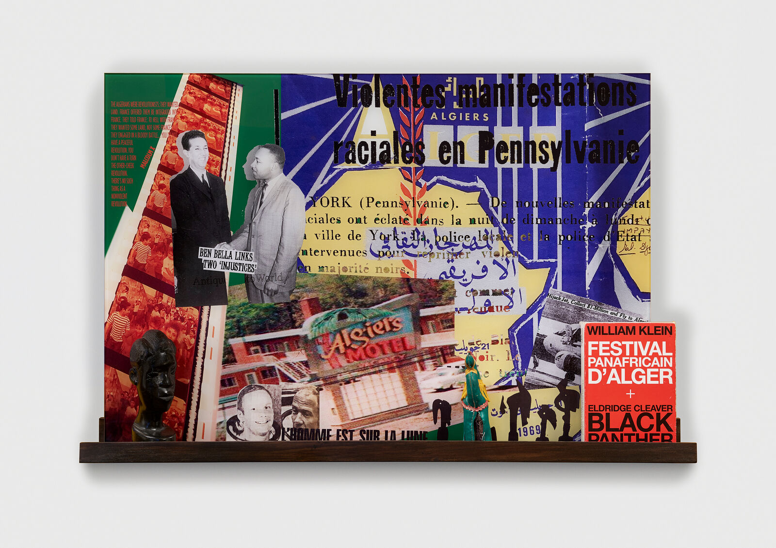 A collage of various images on a wall with a book on it.