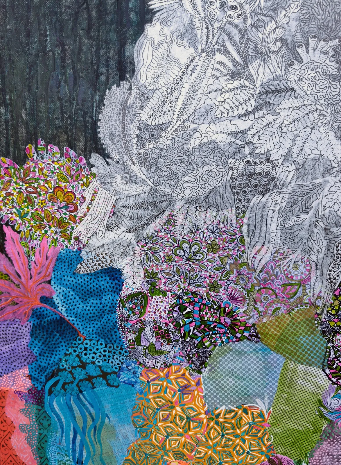 A figure in a white dress stands against a dark background, surrounded by a vibrant explosion of colorful coral-like shapes.