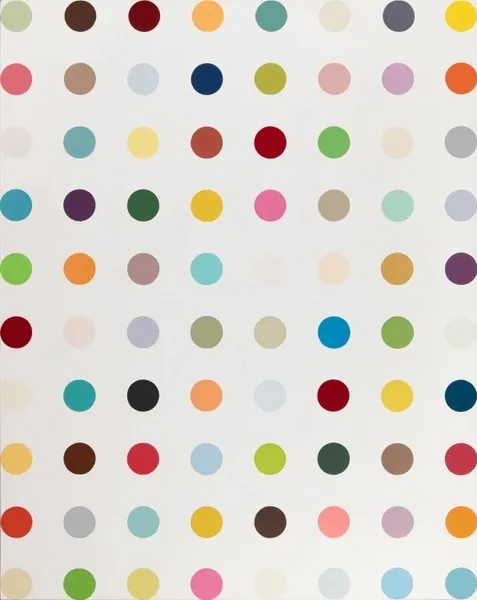 A white wall with many different colored dots on it.