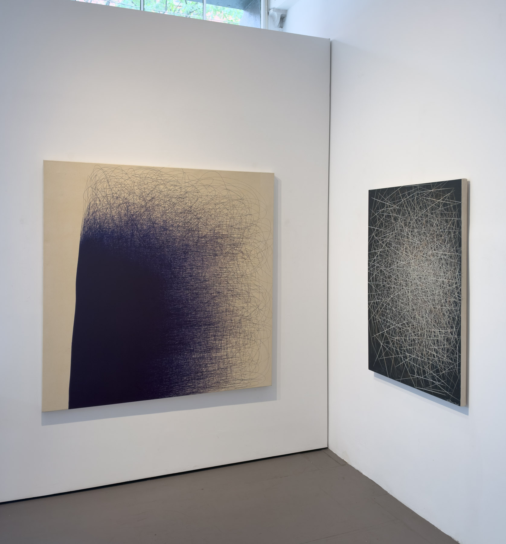 A dense abstract composition of purple ink lines forming a dark, organic shape against a pale background.