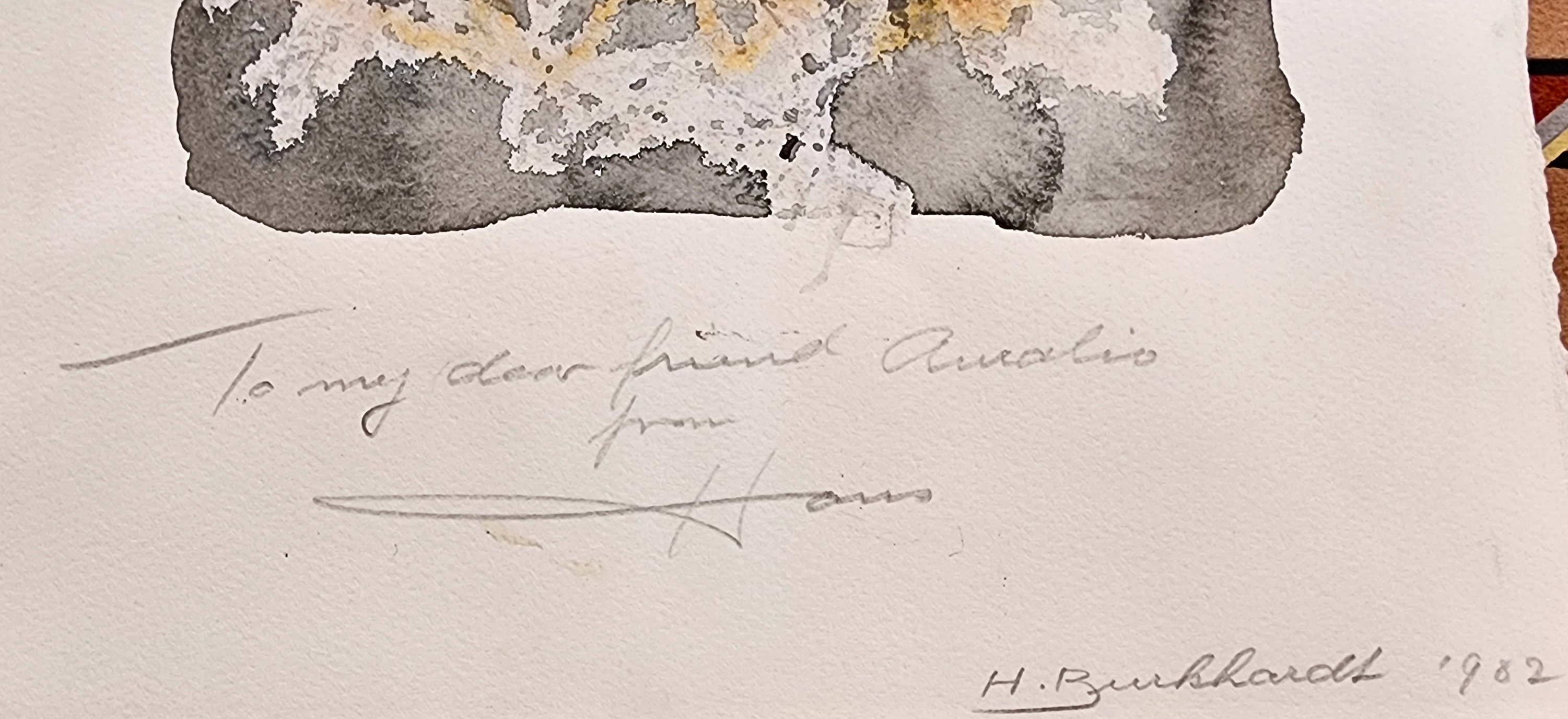 A black and orange painting on a piece of paper.