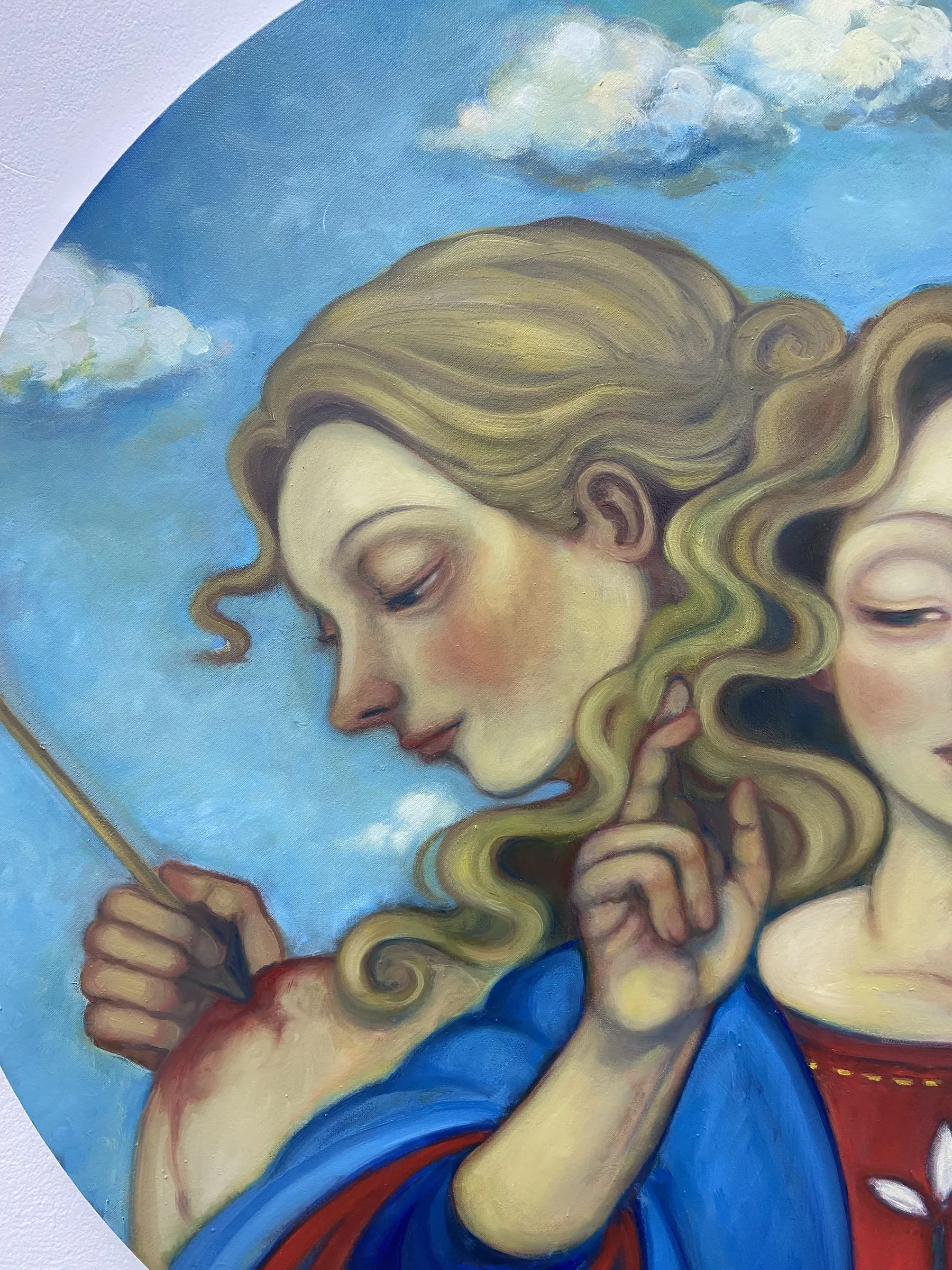 A painting of two angels holding a stick in their hands.