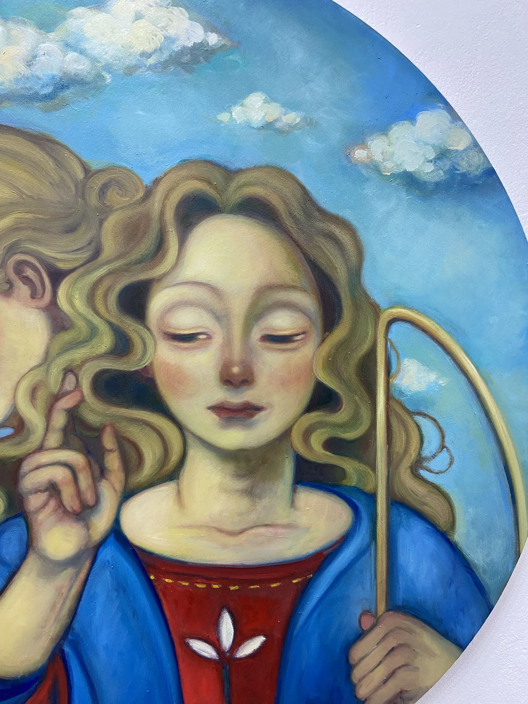 A painting of two angels holding a stick in their hands.
